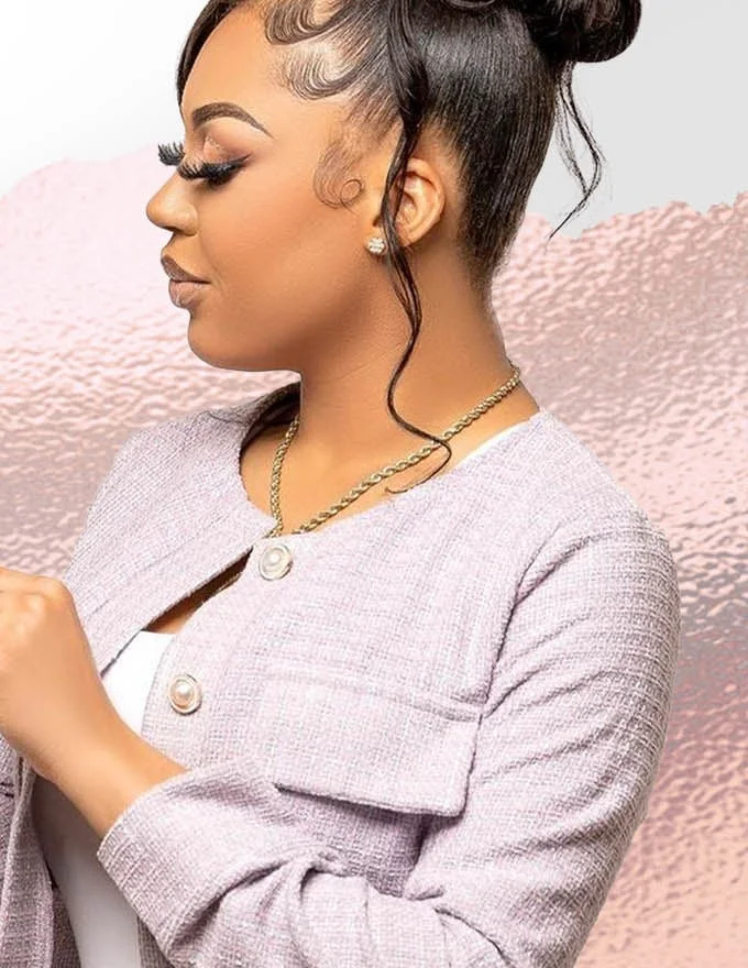 The founder of Infiniti Beauty, a weave specialist of fifteen years, wearing a sleek high bun with laid edges